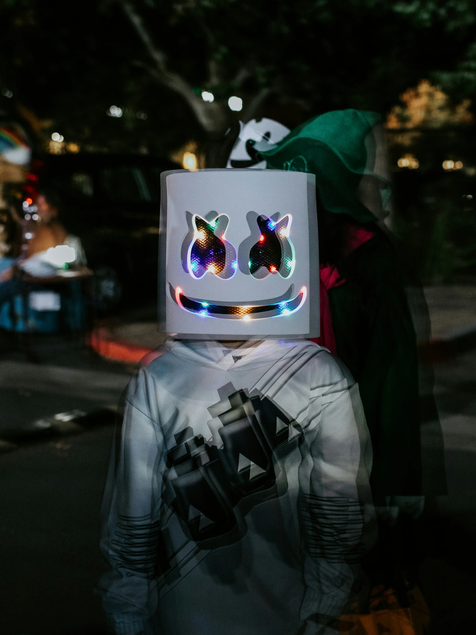 a person with a costume with a box on their head is standing in the street