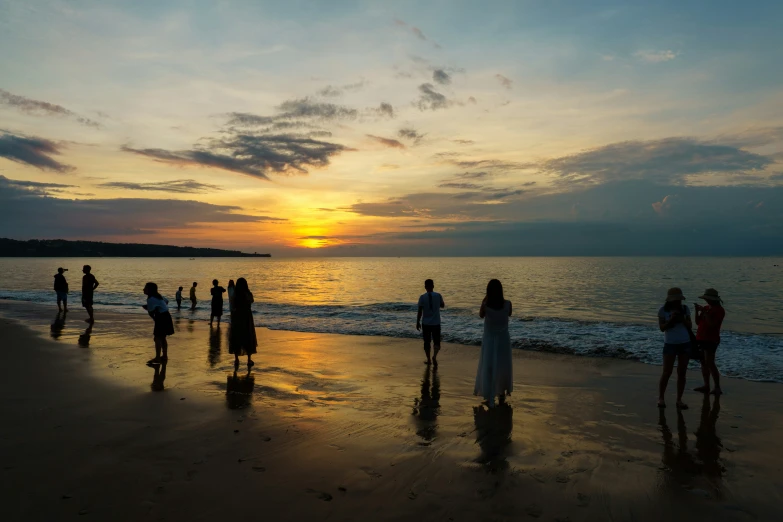 the people are on the beach and walking