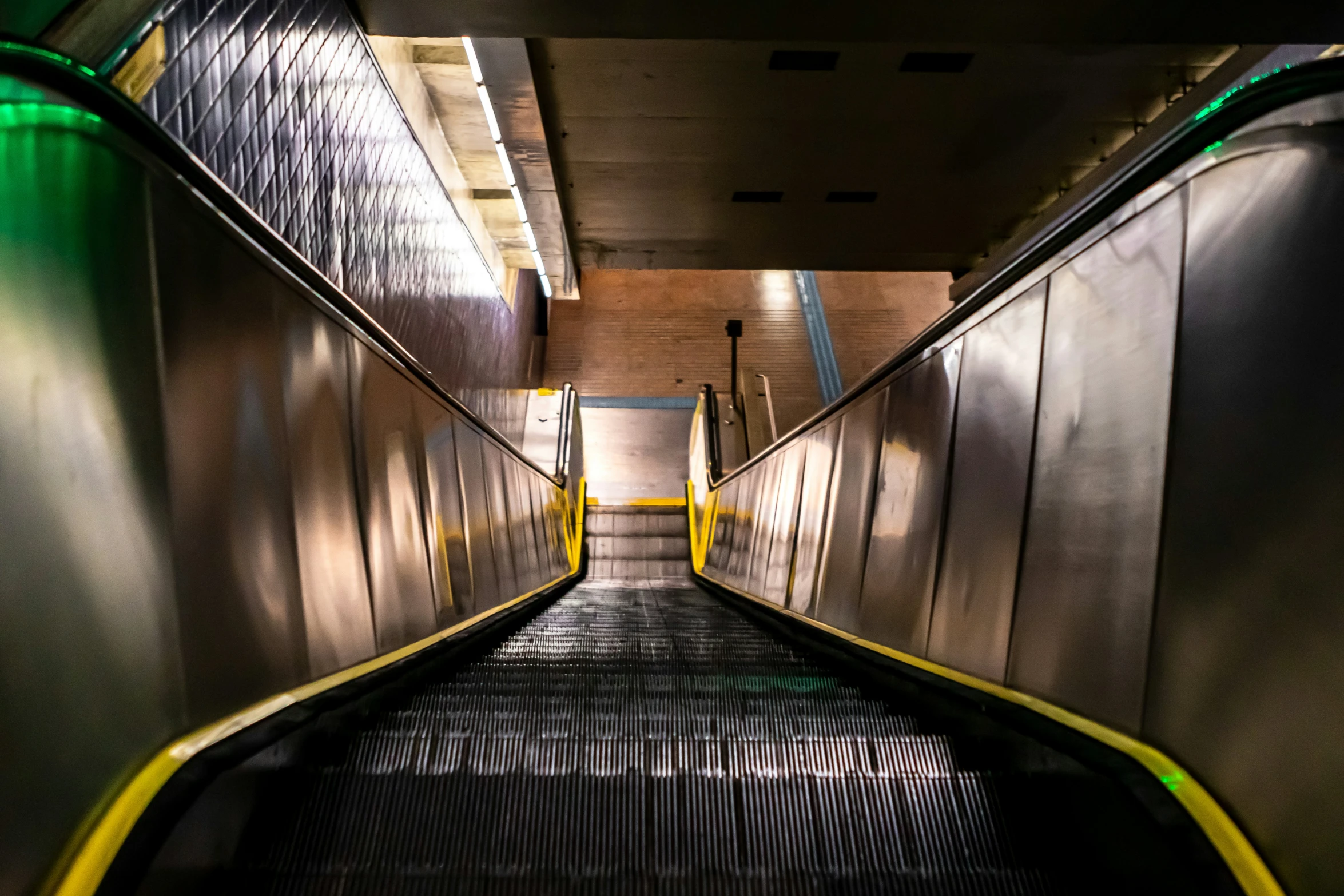 an empty hallway with yellow and green stairs