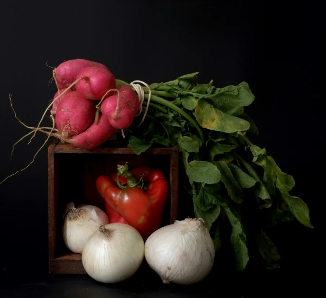 a bunch of vegetables sitting in a square box