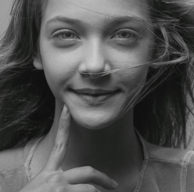 a woman is smiling with a mustache on her nose