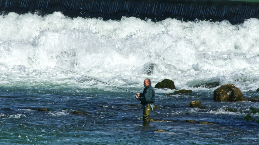 a man standing on top of a wave covered beach