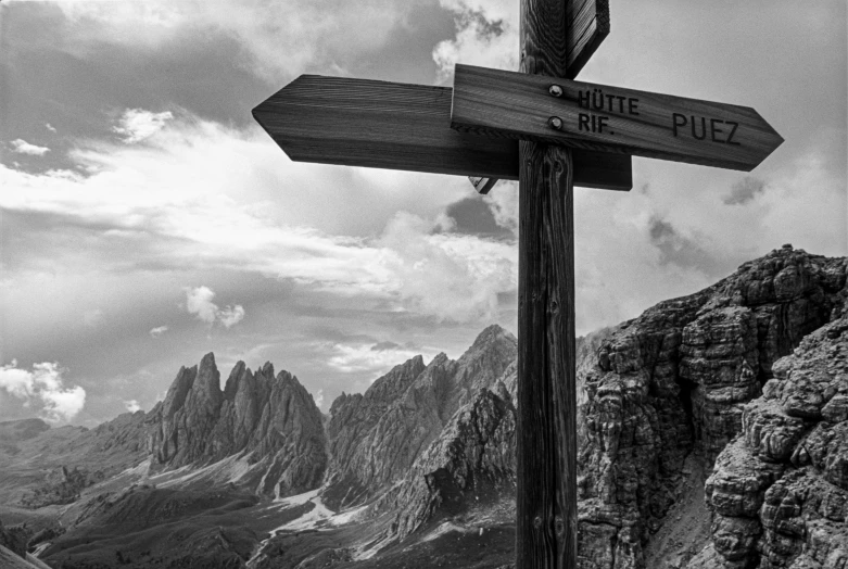 a black and white image of a mountain with a sign saying the route of the alps