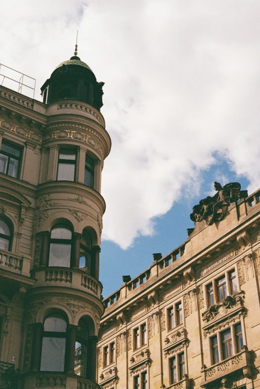 a large building next to a tall building with a sky background