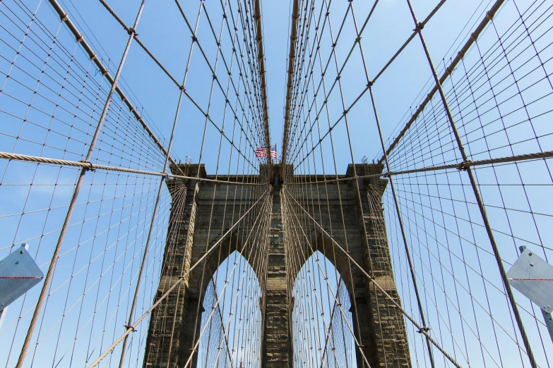 the view looking up at a bridge from below