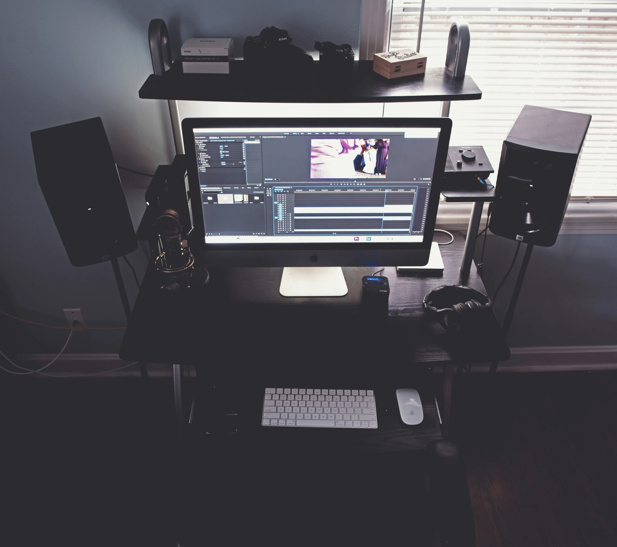 there is a computer on the desk with some speakers