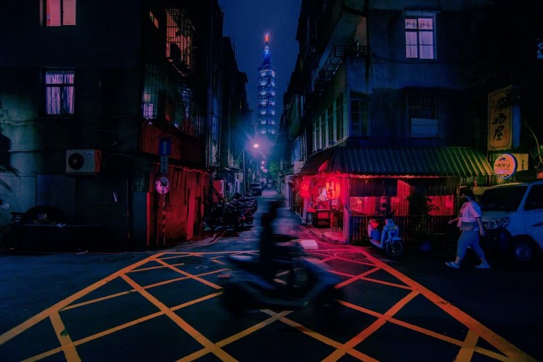 a person riding a motorcycle in the street on an empty street