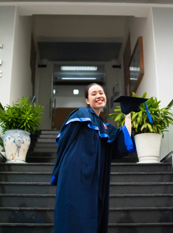 a young woman smiles as she stands on the steps