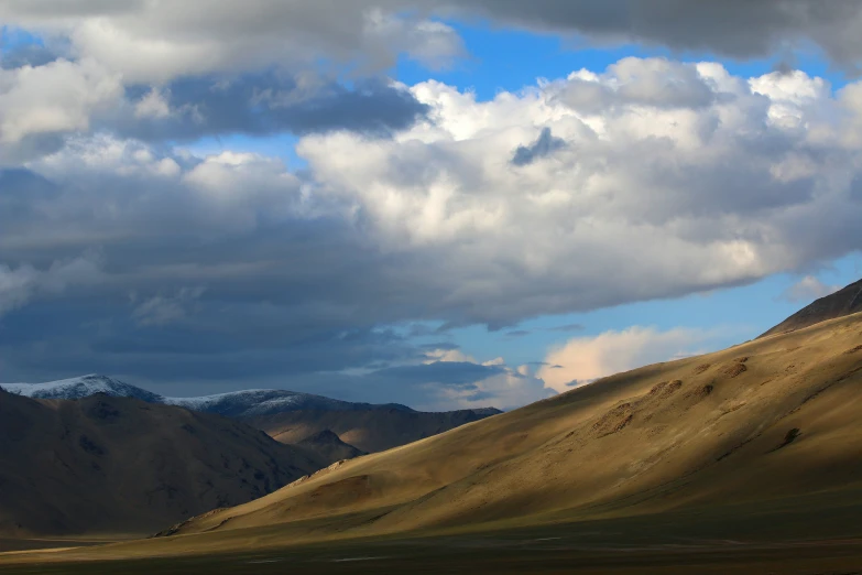 a scenic view of a vast mountain range and the sky is white