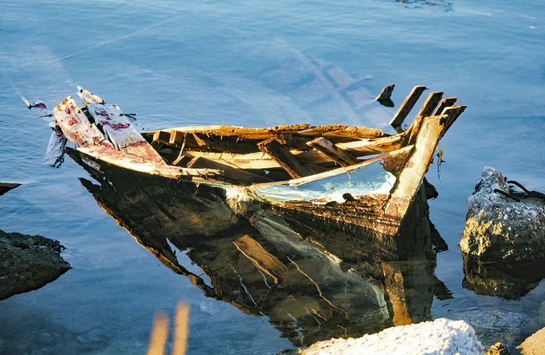 a boat sitting on the surface of a body of water