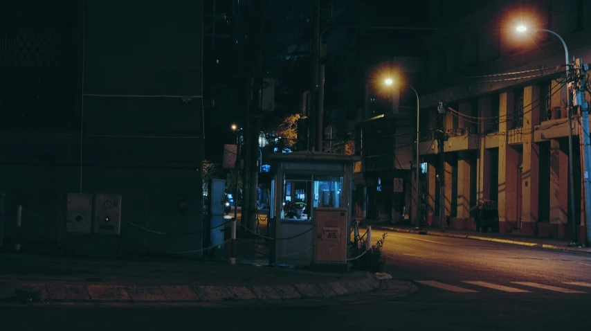 a dark street at night with two people in a small bus