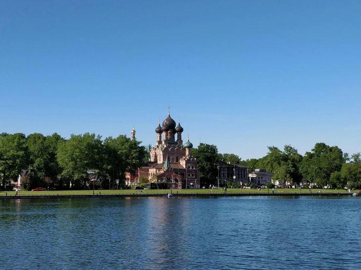a large church in the background on a lake