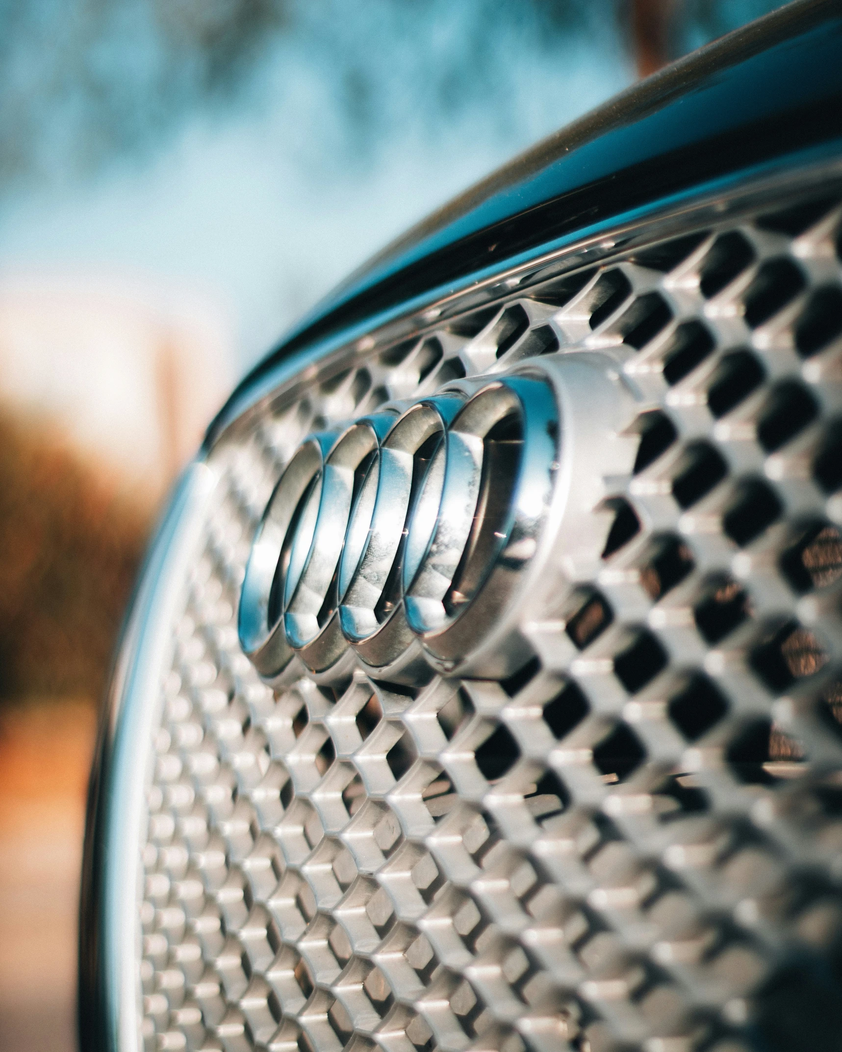 an automobile badge is seen on the grills of a car