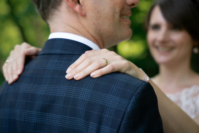 the bride and groom are holding each other outside