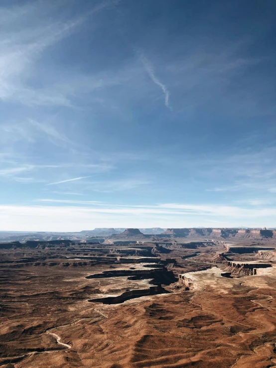 an empty river in the middle of a desert with sp hills