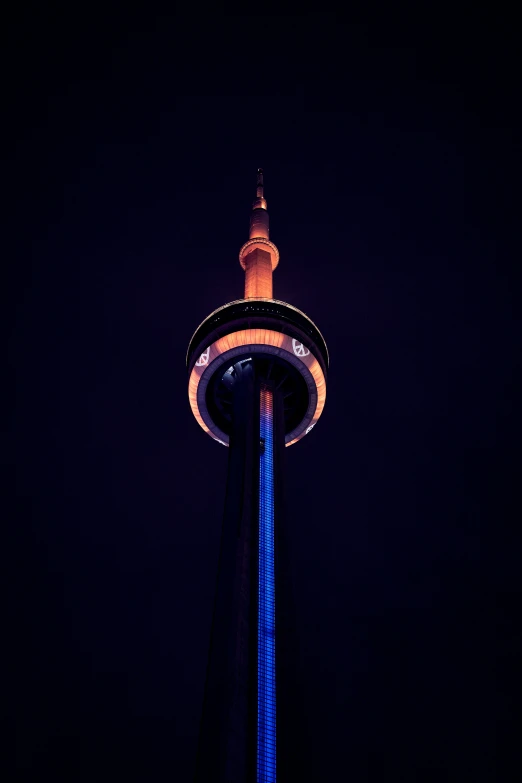 a tall tower lit up in the dark with some lights on