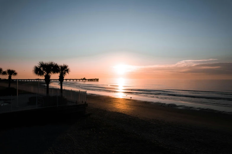 a sunset and beach view taken from a deck