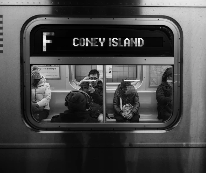 a group of people sitting on the subway seat