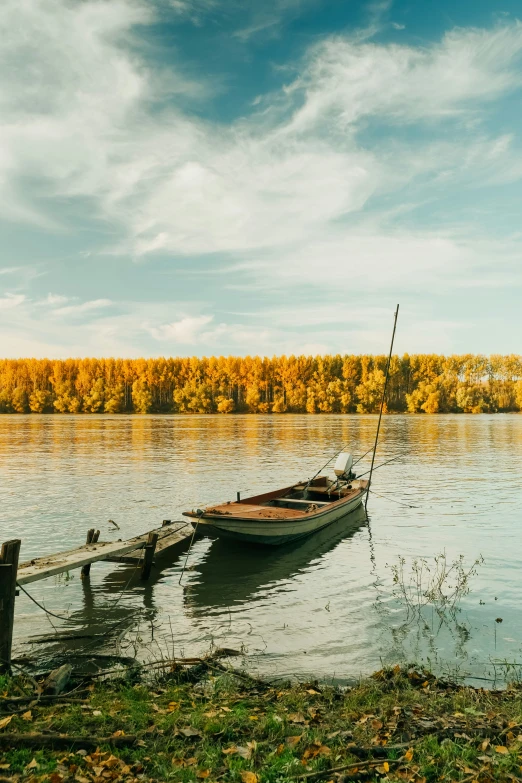 the boat is tied to a wooden post in the water