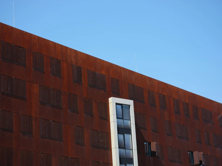 the side of a building with a large window next to it