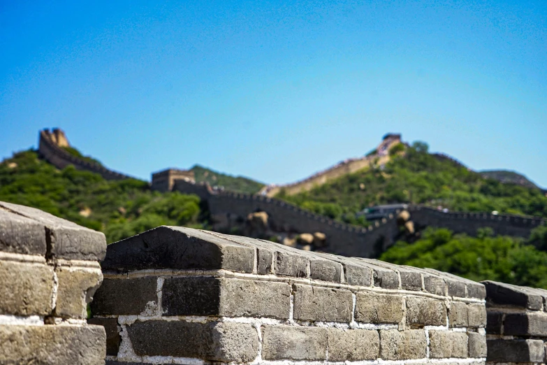 a large wall is shown with a hill in the background