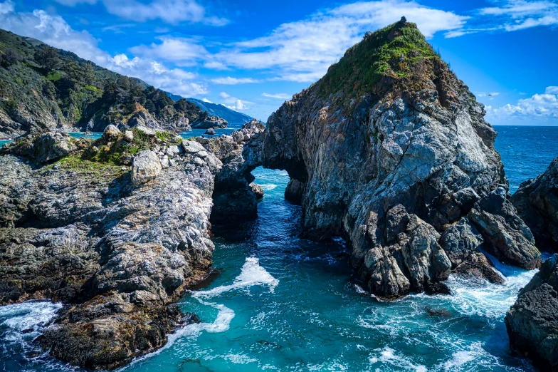 a rock bridge that is in the ocean