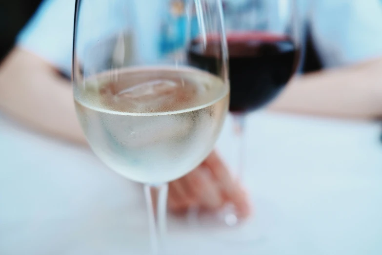 two glasses of wine that are sitting on the table