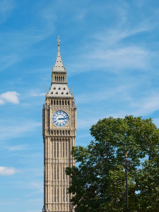 the clock tower is tall and has a very short bell