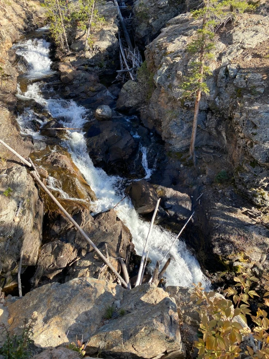 there is a small waterfall going through a mountain