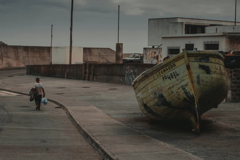 a man that is walking down some concrete