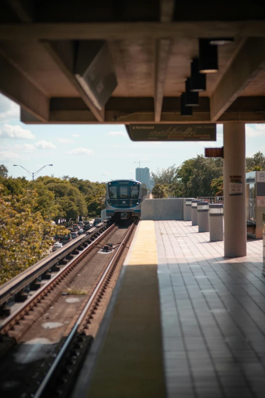 a train passing by an overpass with many vehicles