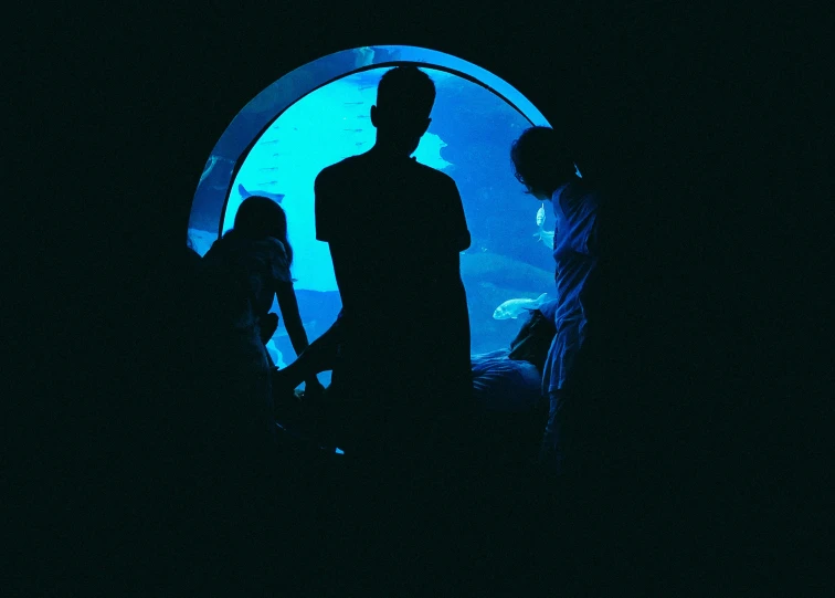 a group of people standing in front of a tunnel