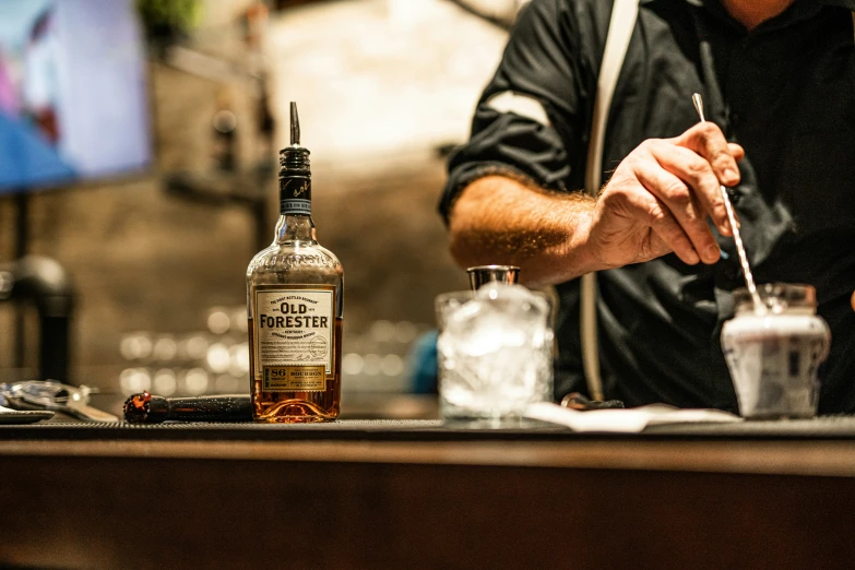 bartender at work preparing to shake a glass in a bar