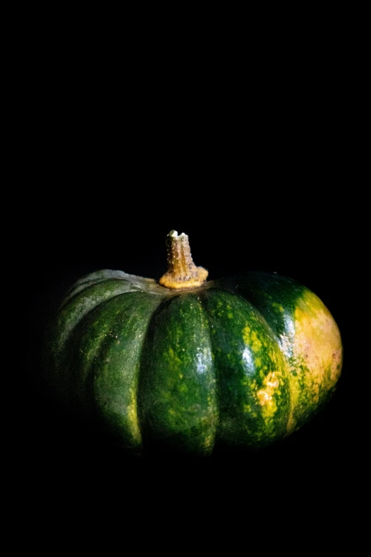 a green pumpkin is next to another orange