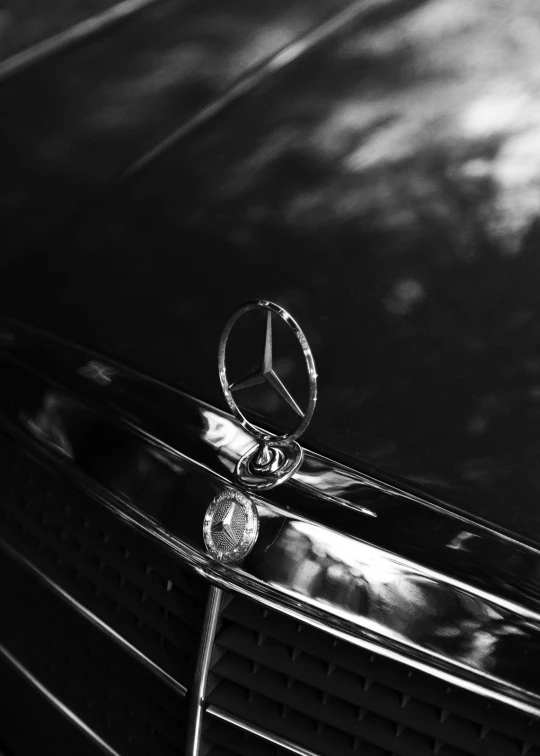 a mercedes badge is shown on the hood of a car