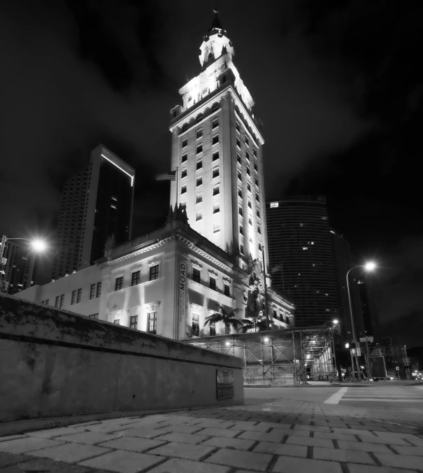 a clock tower at night in the city