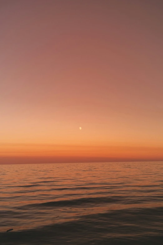 some clouds are visible at sunset over water