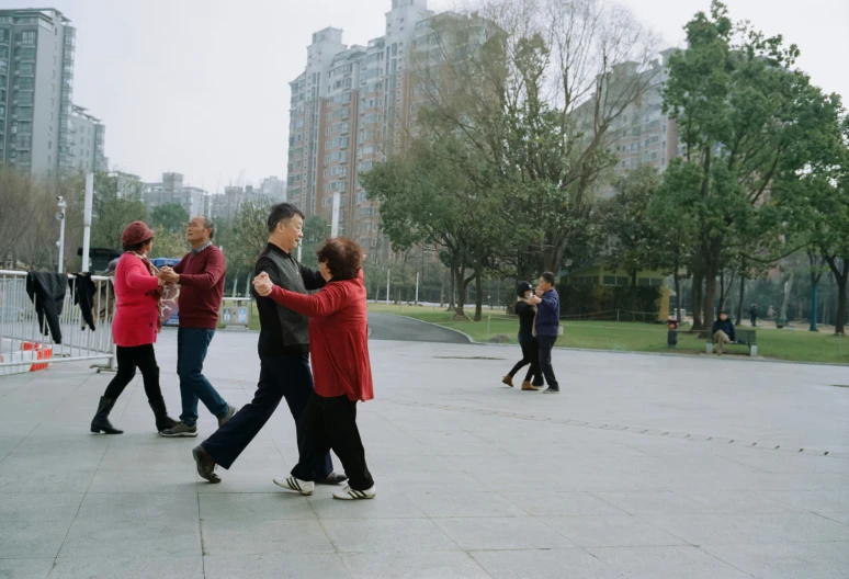 group of people walking down street with building behind them