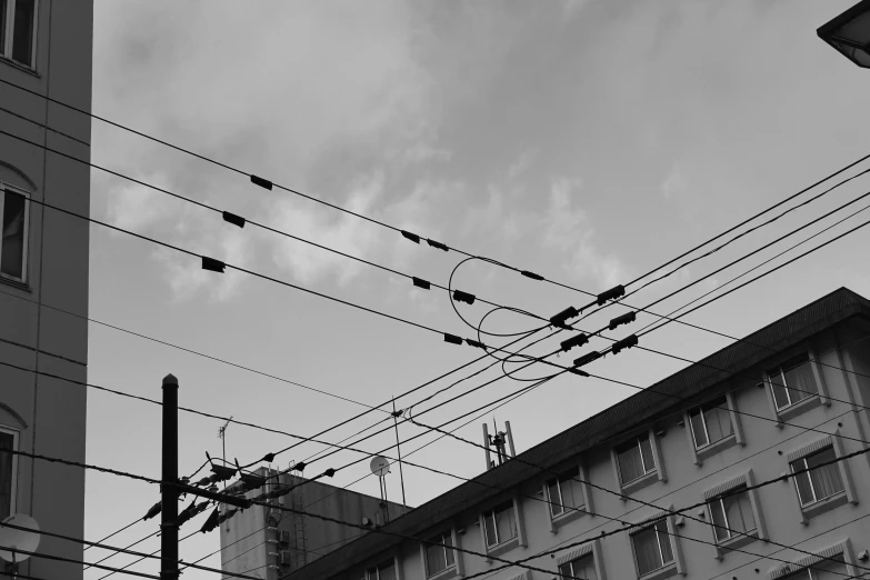 a view of the side of a building with power lines in front