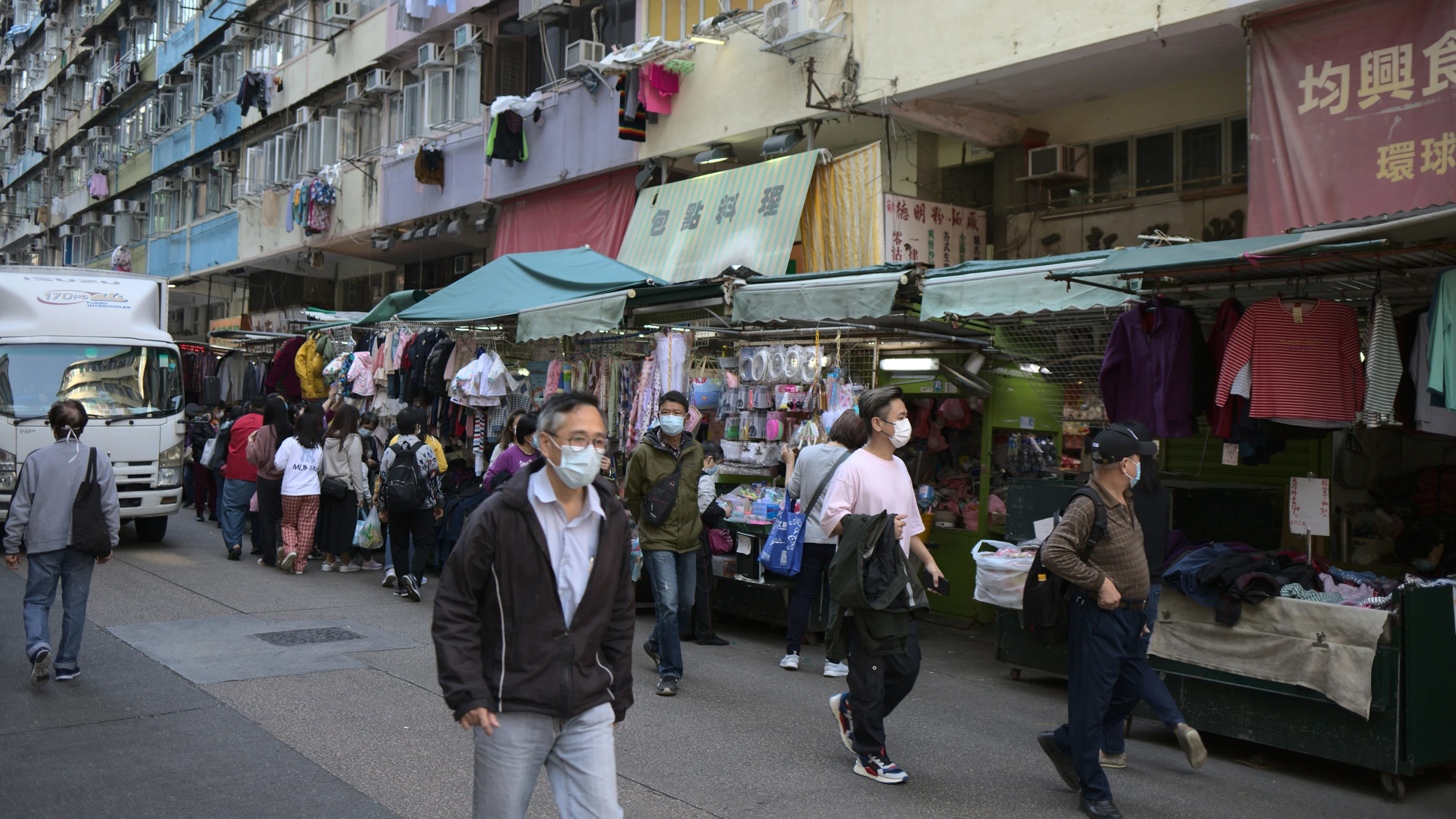 a busy shopping area with people walking around