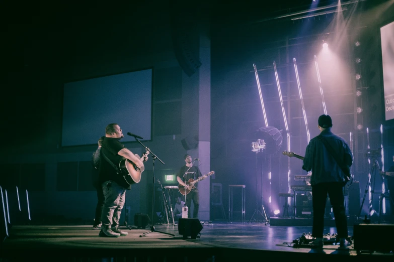 a band performing in a concert hall on stage