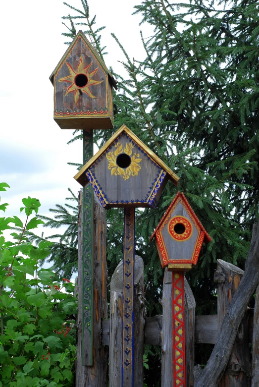 four wood cuckoo clocks standing in the grass
