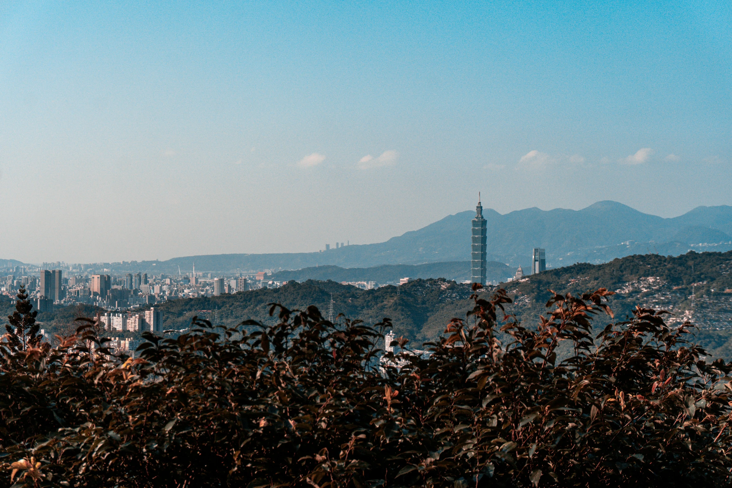 a very tall building sitting above a large city