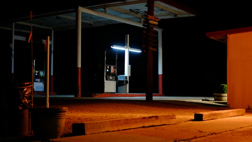 the empty street is lit by the lights of traffic lights