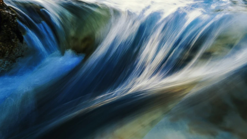 a waterfall with water flowing down the side of it