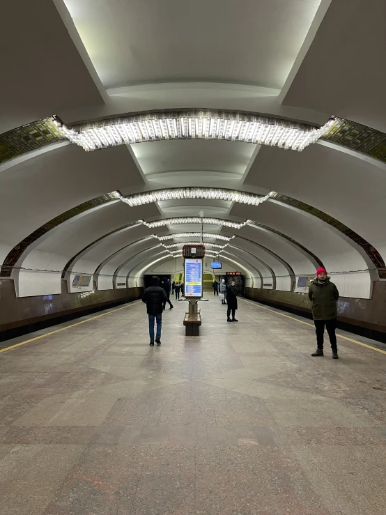 people standing in the middle of an empty station