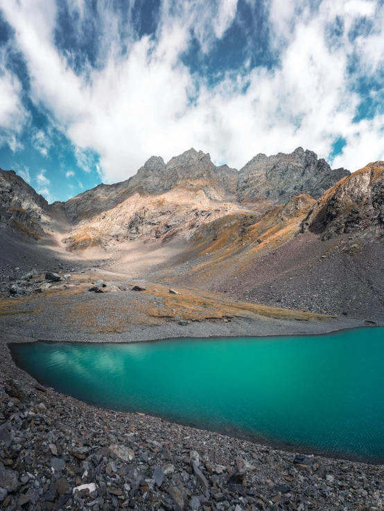 blue lake near mountains under the clouds