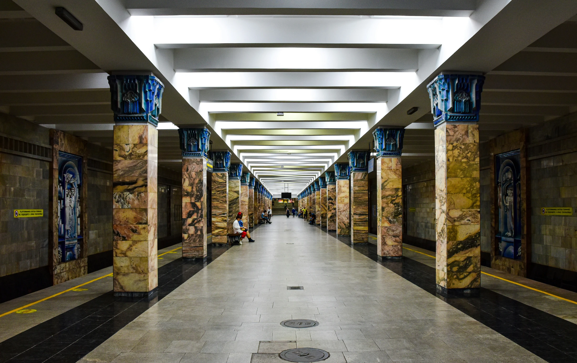 the inside of an indoor hallway has marble columns