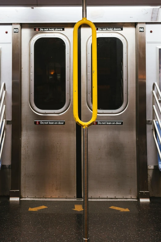 a subway door with two handles to allow the people to climb