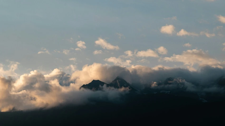 this is clouds flying over the mountain and a bird flying overhead